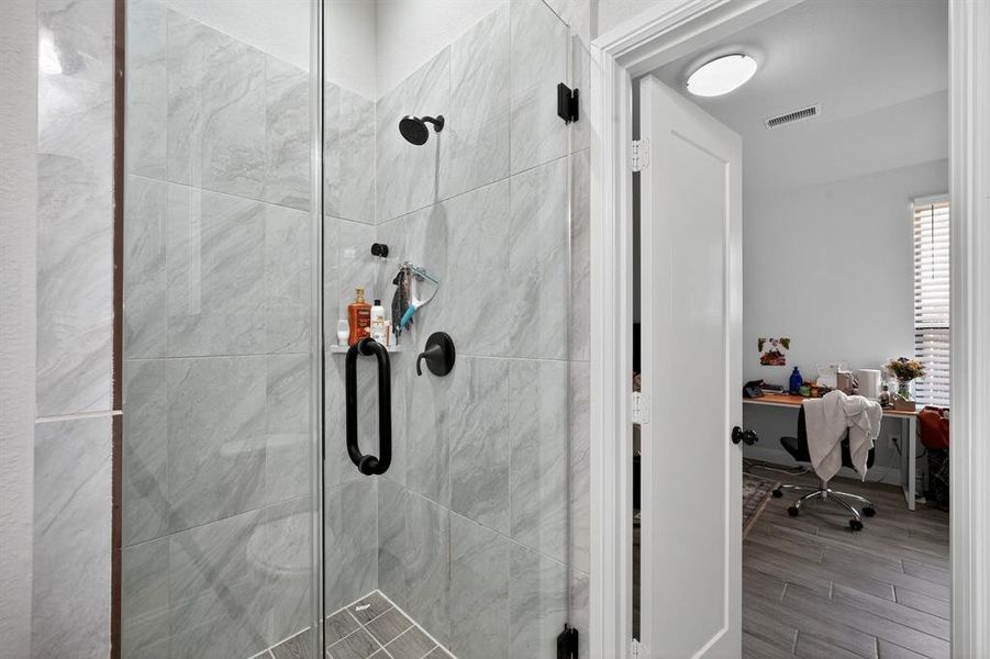 Bathroom featuring a stall shower and wood finished floors