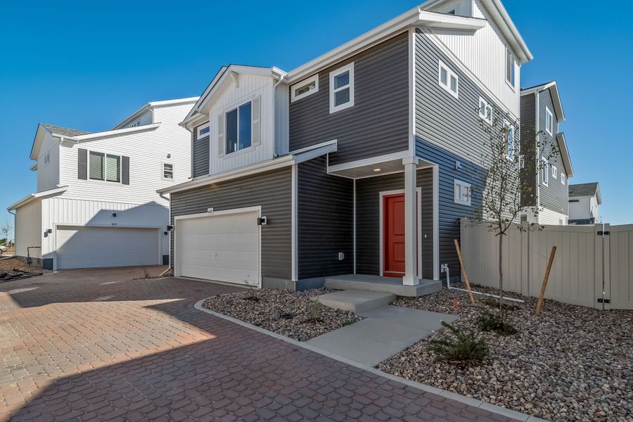 Front exterior of a new home in Muegge Farms, Bennett, CO, highlighting curb appeal (Image 1). Front exterior of a new home in Muegge Farms, Bennett, CO, highlighting curb appeal (Image 1).