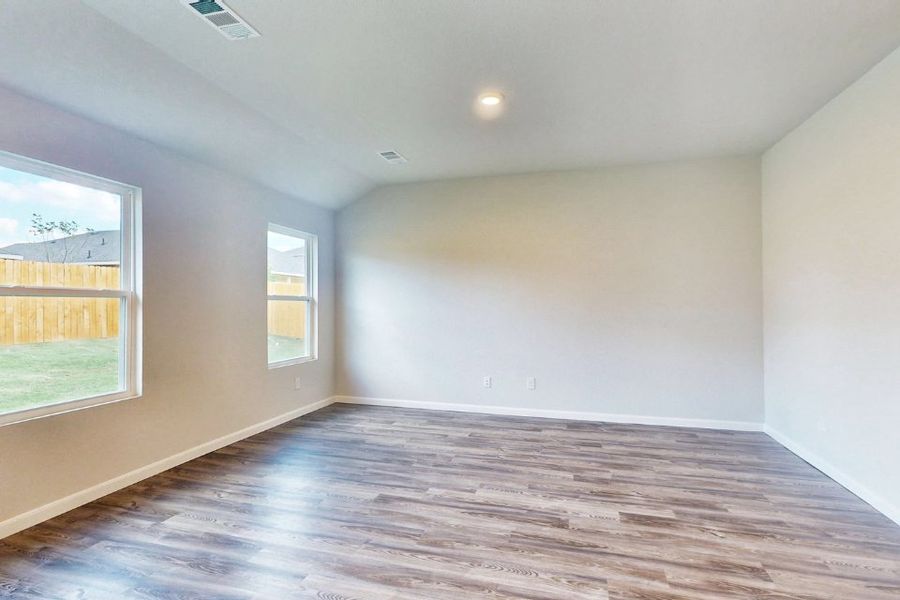 A room with a wood floor and windows. A room with a wood floor and windows.