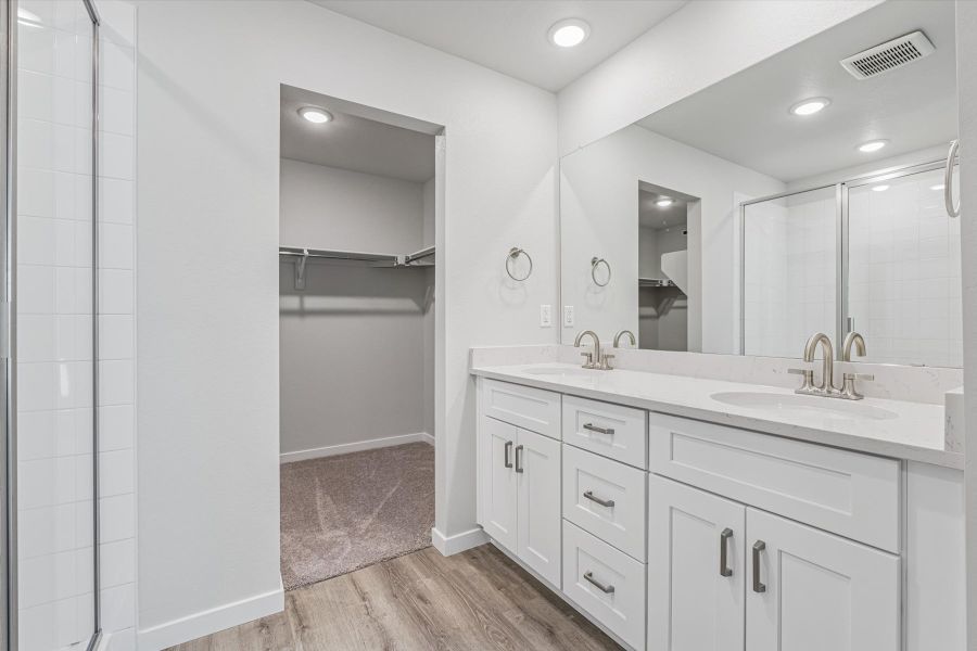 A bathroom with a shower and sink.