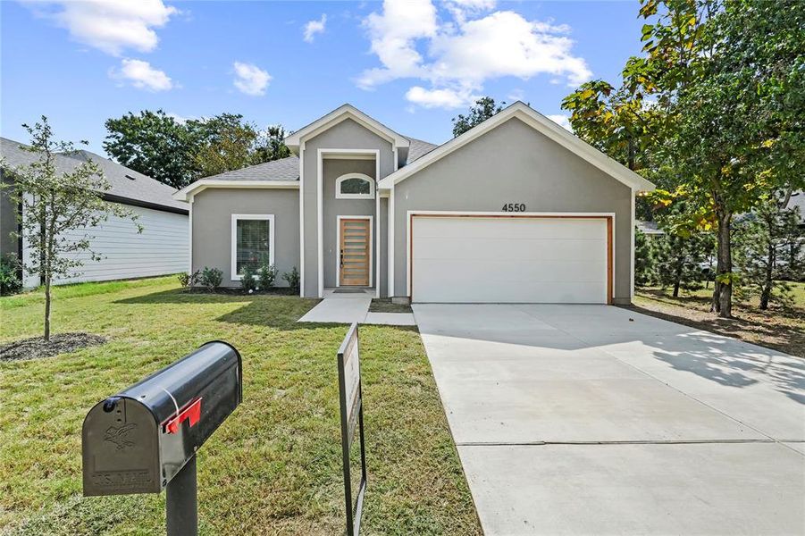 View of front of home featuring stucco siding, driveway, a front yard, a garage, and a shingled roof View of front of home featuring stucco siding, driveway, a front yard, a garage, and a shingled roof