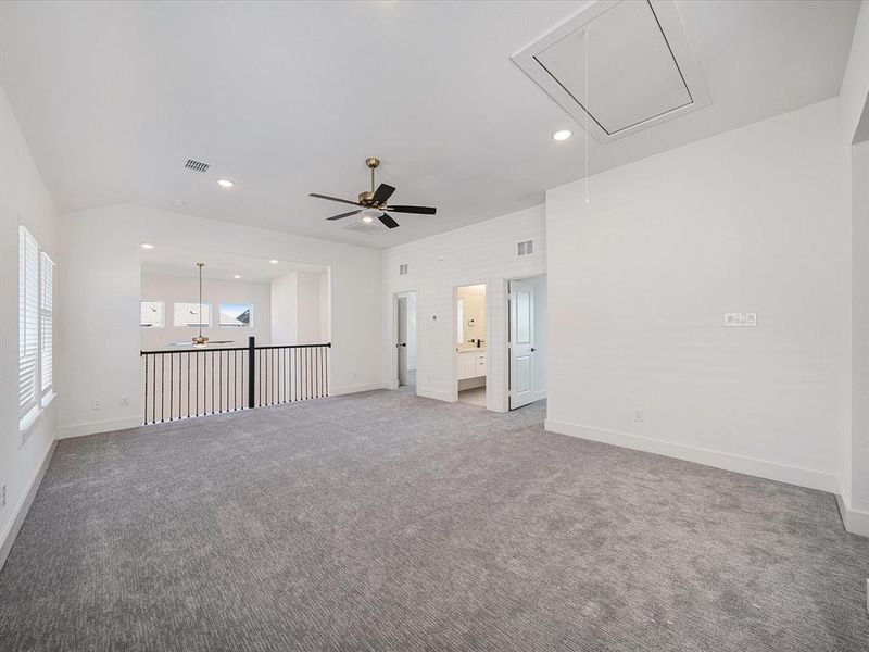 Carpeted empty room featuring attic access and recessed lighting