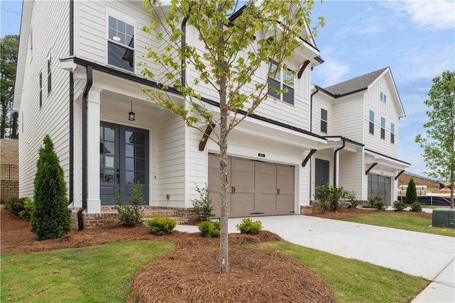 Front exterior of a new home in Palisades Single Family, Cumming, GA, highlighting curb appeal (Image 24).