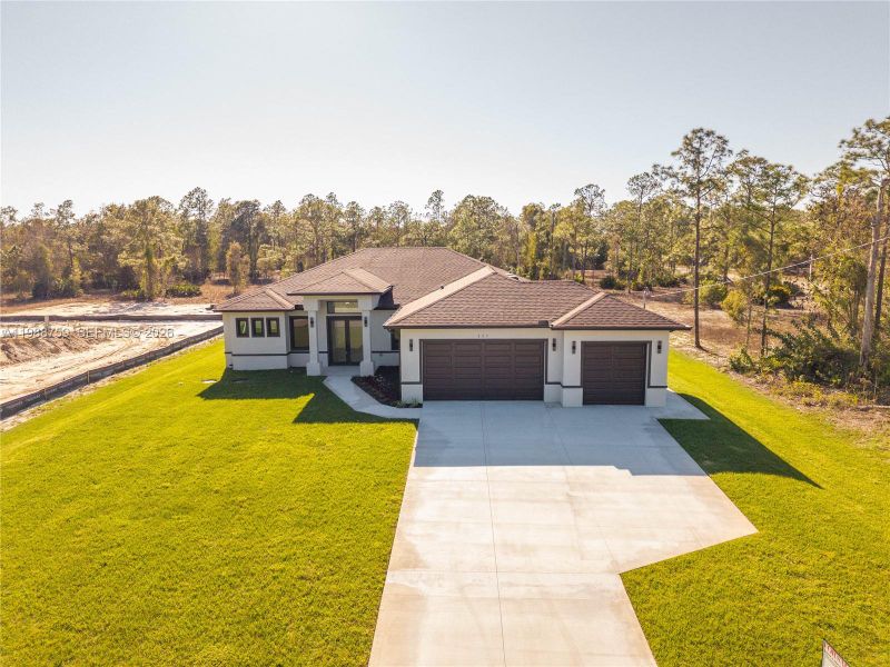 Front exterior of a new home in , Lehigh Acres, FL, highlighting curb appeal (Image 21). Front exterior of a new home in , Lehigh Acres, FL, highlighting curb appeal (Image 21).