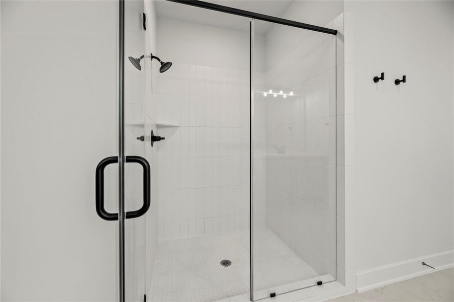 Step into the sleek, glass-enclosed shower, spacious, stylish, and designed for a rejuvenating start (or finish) to your day.