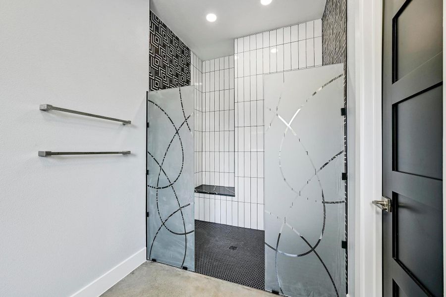 Amazing spa-inspired two person walk-in shower with custom frameless glass, two shower heads, designer backsplash, and bench seating. Amazing spa-inspired two person walk-in shower with custom frameless glass, two shower heads, designer backsplash, and bench seating.