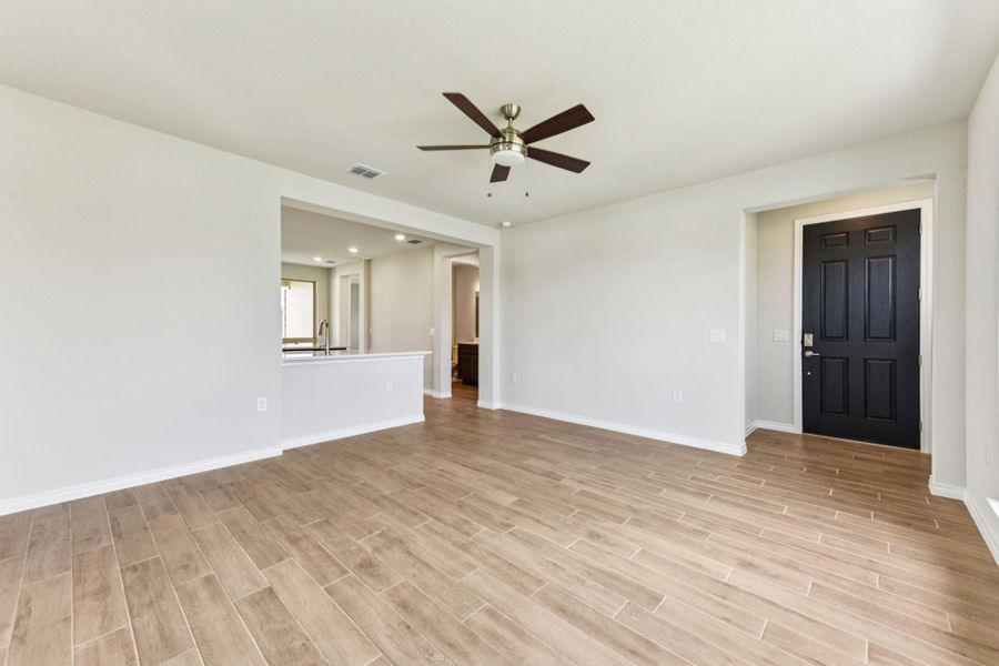 Spare room featuring light wood-type flooring and a ceiling fan