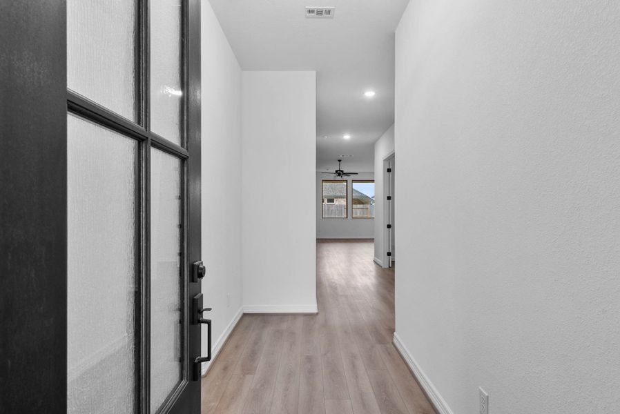 The home features a welcoming entry that flows naturally into the open living area.