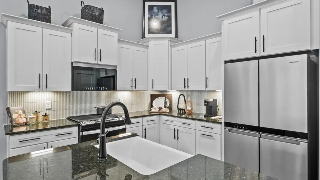 Modern kitchen with streamlined island for easy prep, storage, and gathering Modern kitchen with streamlined island for easy prep, storage, and gathering