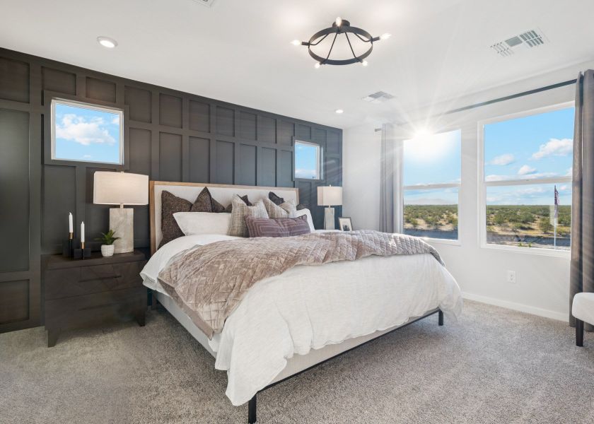 A bedroom with a large window.