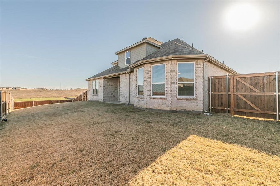 Rear view of house featuring a lawn