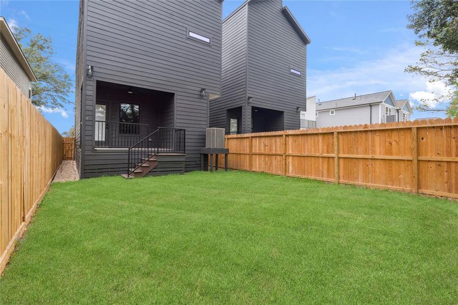 The backyard offers a serene space for relaxation, fully fenced for privacy and featuring ample lawn space for all your outdoor activities.