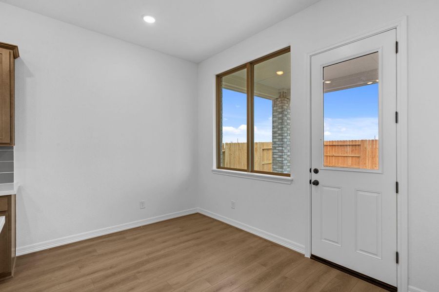 The breakfast nook is bathed in natural light, perfect for slow mornings and casual meals.