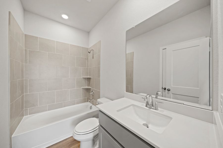 A bathroom with a tub sink and toilet. A bathroom with a tub sink and toilet.