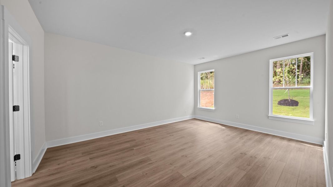 First-class hardwood floors and tasteful finishes elevate the private retreat of this exceptional primary suite