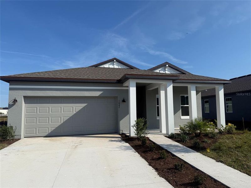 Front exterior of a new home in Tyson Reserve, St. Cloud, FL, highlighting curb appeal (Image 1). Front exterior of a new home in Tyson Reserve, St. Cloud, FL, highlighting curb appeal (Image 1).