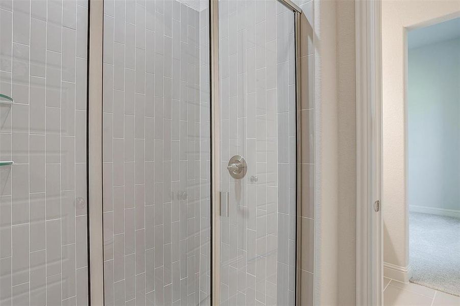 Bathroom featuring tile patterned flooring and walk in shower