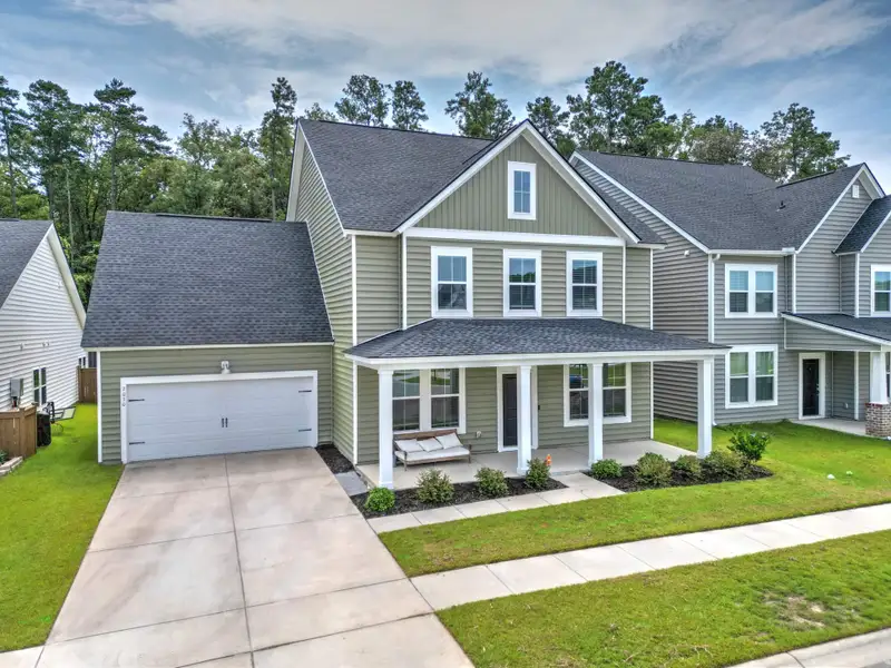 Front exterior of a new home in Sweetgrass at Summers Corner, Summerville, SC, highlighting curb appeal (Image 27). Front exterior of a new home in Sweetgrass at Summers Corner, Summerville, SC, highlighting curb appeal (Image 27).
