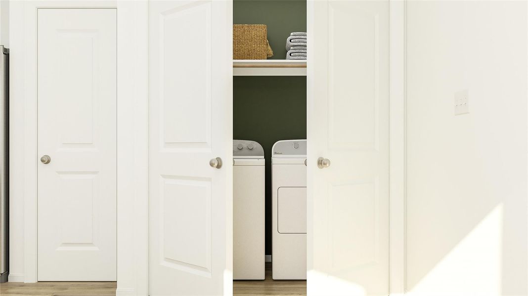 Laundry area with washing machine and clothes dryer and light wood-type flooring Laundry area with washing machine and clothes dryer and light wood-type flooring