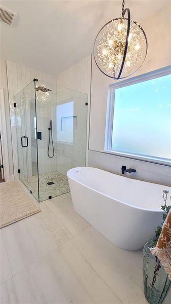 Bathroom featuring tile patterned flooring, plus walk in shower, and a chandelier