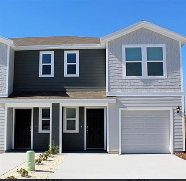 Front exterior of a new home in The Towns at Laurel Commons, Ocala, FL, highlighting curb appeal (Image 2).