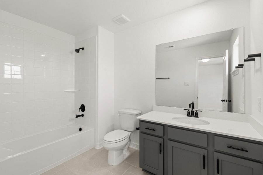 The secondary bath features tile flooring, white cabinetry and light countertops and a shower/tub combo. Perfect for accommodating any visiting family and friends. The secondary bath features tile flooring, white cabinetry and light countertops and a shower/tub combo. Perfect for accommodating any visiting family and friends.