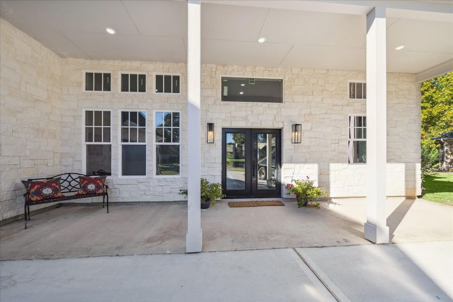 Front forward view of the entry, 12 ft. Ceilings and full Veranda. Beautiful Stately Sconces flanking the Double Door Entry