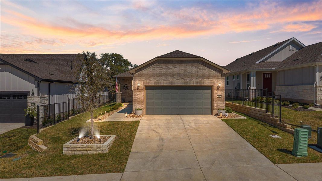 View of front of property featuring brick siding, concrete driveway, and a garage View of front of property featuring brick siding, concrete driveway, and a garage