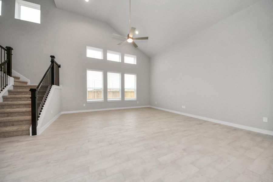 Welcome family and guests to your charming living room! With its high ceilings,recessed lighting, ceiling fan, custom paint, beautiful flooring, and large windows that letin abundant natural light, this room is perfect for gatherings. Sample photo of completed home with similar floor plan. Actual colors and selections may vary. Welcome family and guests to your charming living room! With its high ceilings,recessed lighting, ceiling fan, custom paint, beautiful flooring, and large windows that letin abundant natural light, this room is perfect for gatherings. Sample photo of completed home with similar floor plan. Actual colors and selections may vary.