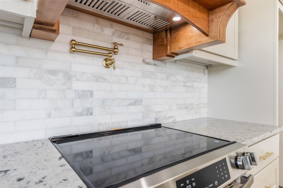 Custom ventahood, pot filler and smooth top range. Custom ventahood, pot filler and smooth top range.