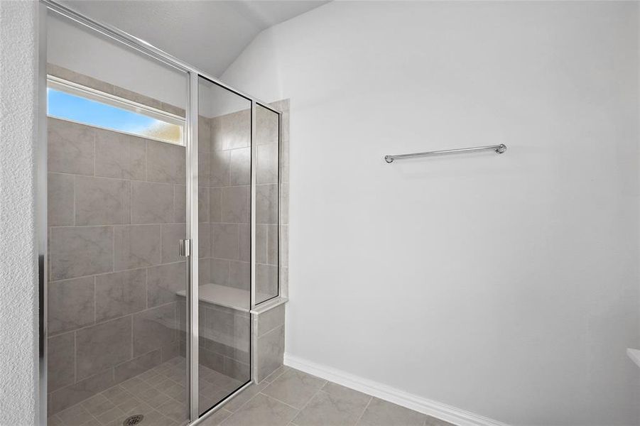 Full bathroom featuring a shower stall and tile patterned flooring Full bathroom featuring a shower stall and tile patterned flooring
