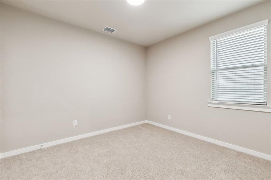 Bedroom in the Elm home plan by Trophy Signature Homes – REPRESENTATIVE PHOTO