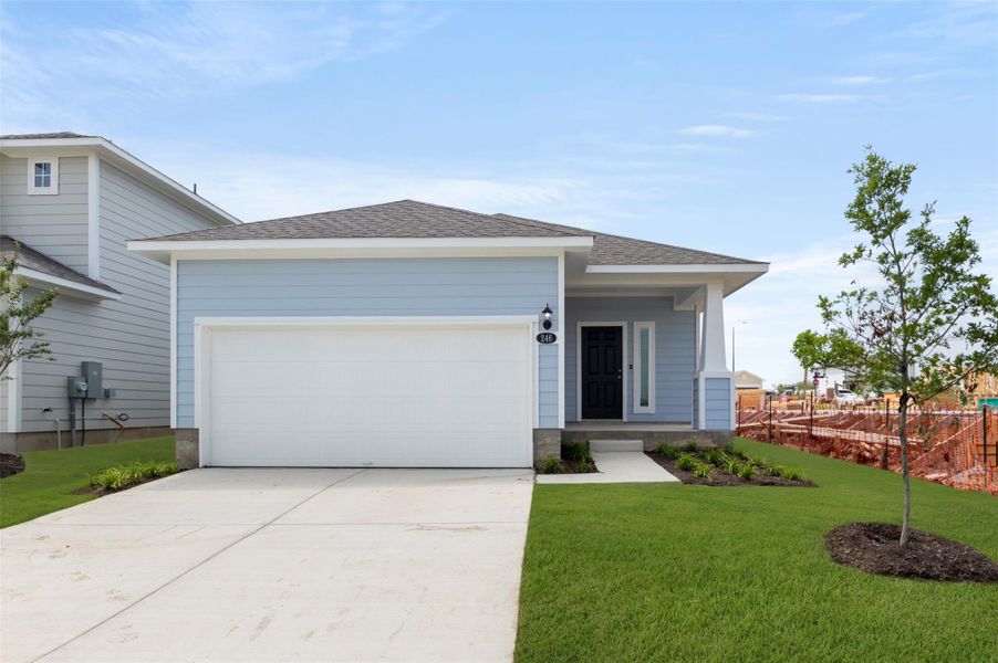 View of front of home featuring concrete driveway, a garage, and a shingled roof