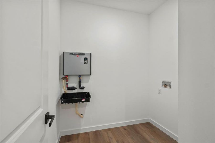 Washroom featuring washer hookup and dark hardwood / wood-style flooring