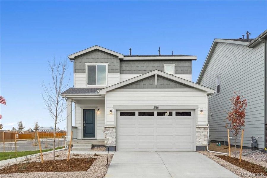 Front exterior of a new home in Farmlore, Brighton, CO, highlighting curb appeal (Image 2).