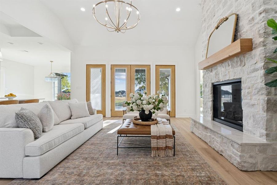 Natural light doesn't get much better than this; Taj Mahal quartzite on hearth, stone fireplace to ceiling.