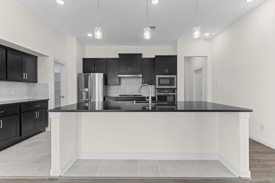 This gourmet kitchen features amazing tall custom cabinets with chic style backsplash and more! This gourmet kitchen features amazing tall custom cabinets with chic style backsplash and more!