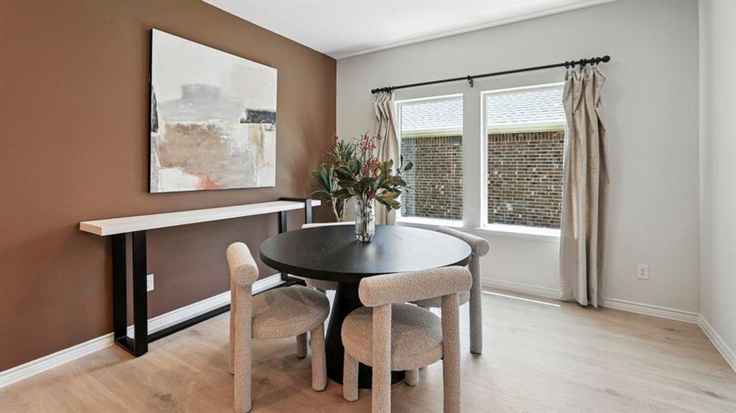 Dining space featuring light wood finished floors and baseboards