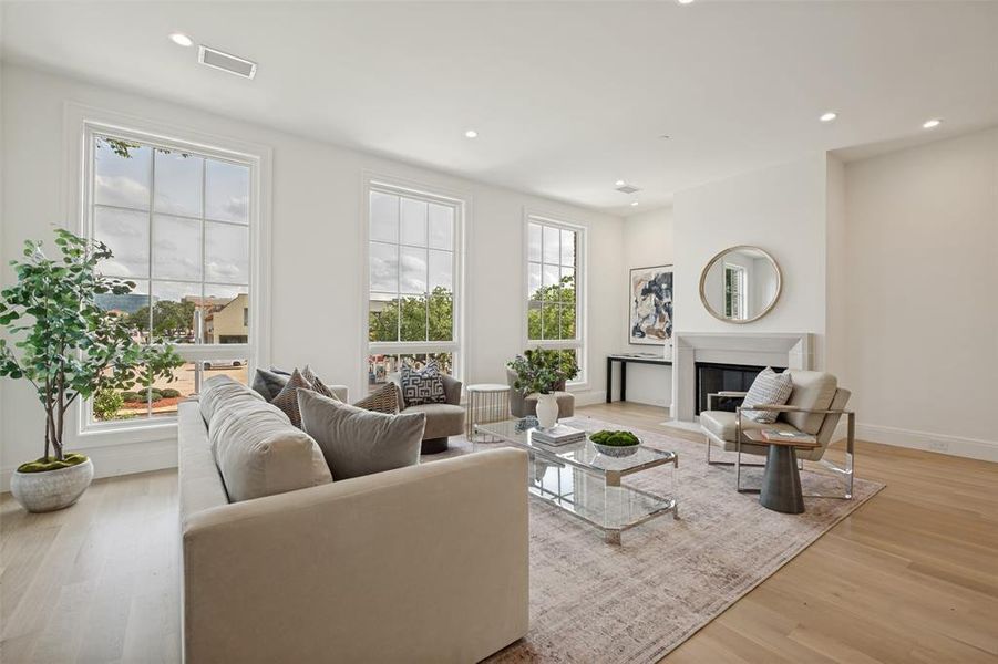 Living room featuring a central fireplace and treetop views from the second floor. Living room featuring a central fireplace and treetop views from the second floor.