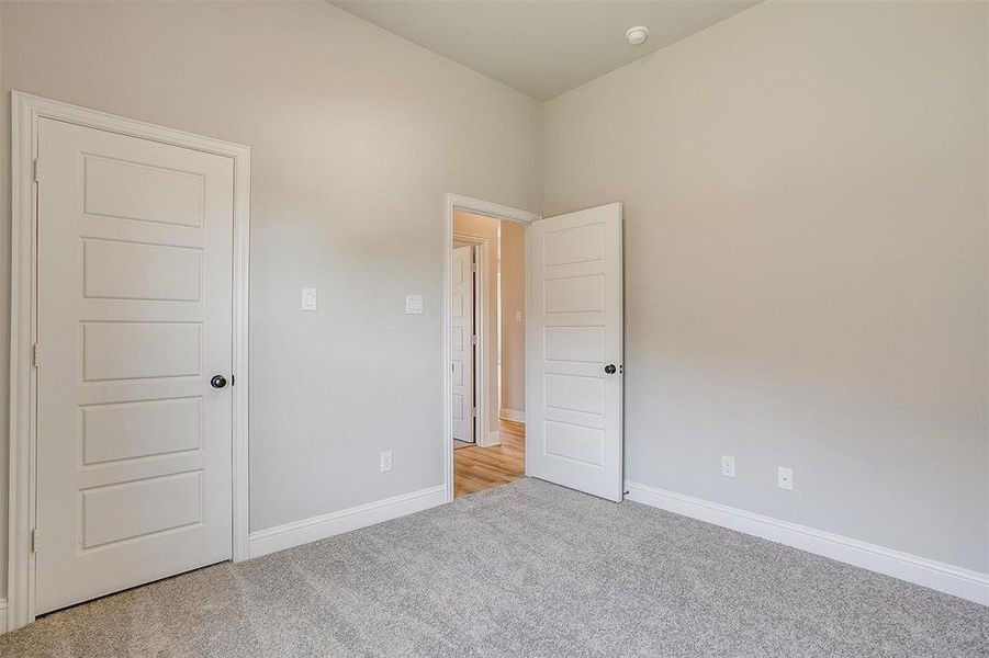 Unfurnished room with light colored carpet