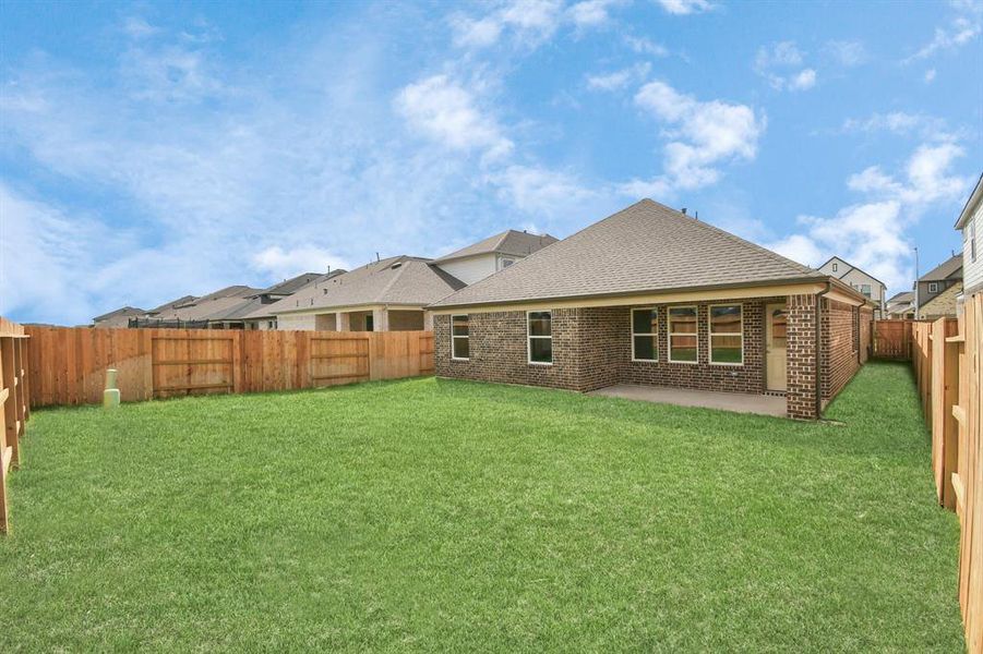 Explore the expansive backyard with its inviting covered patio—a perfect blend of space for the kids to play and adults to unwind.