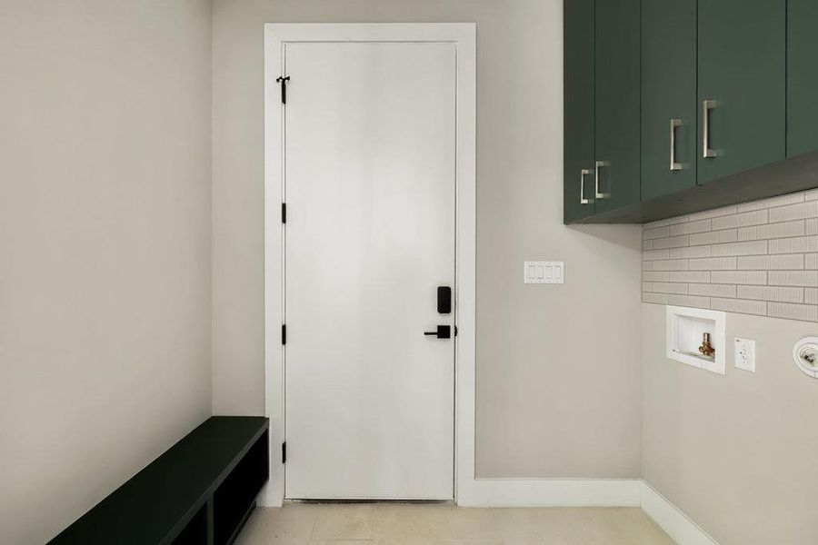 Laundry area with washer hookup and cabinet space