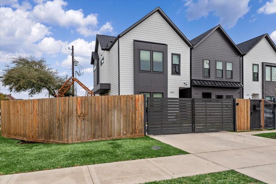 The home is enclosed by automatic driveway gates. Two cars comfortably fit inside the gate with additional parking on the exterior. The home is enclosed by automatic driveway gates. Two cars comfortably fit inside the gate with additional parking on the exterior.