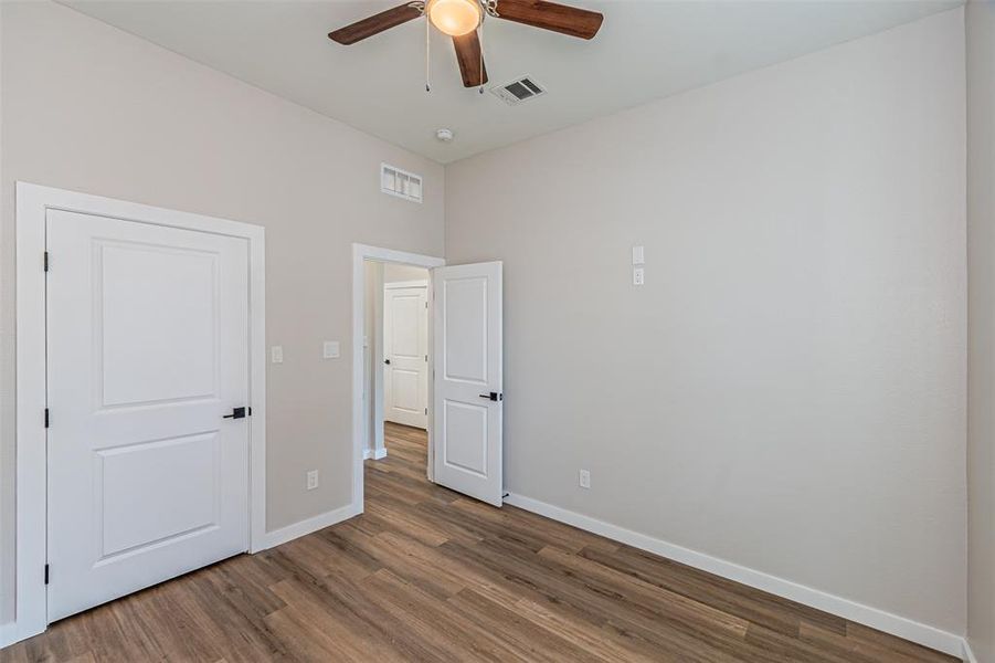 Unfurnished bedroom with wood finished floors and ceiling fan