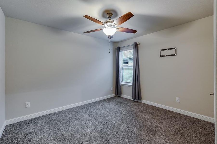 Spare room featuring carpet floors and ceiling fan Spare room featuring carpet floors and ceiling fan