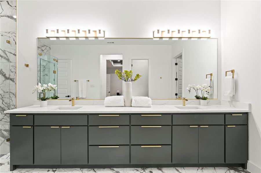 Bathroom with marble finish floor, double vanity, a sink, and a marble finish shower