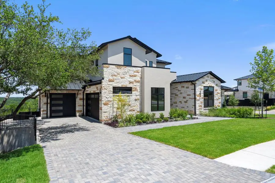 Front exterior of a new home in Milky Way at River Place, Austin, TX, highlighting curb appeal (Image 2).