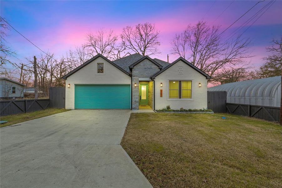 View of front of home featuring concrete driveway, an attached garage, and brick siding