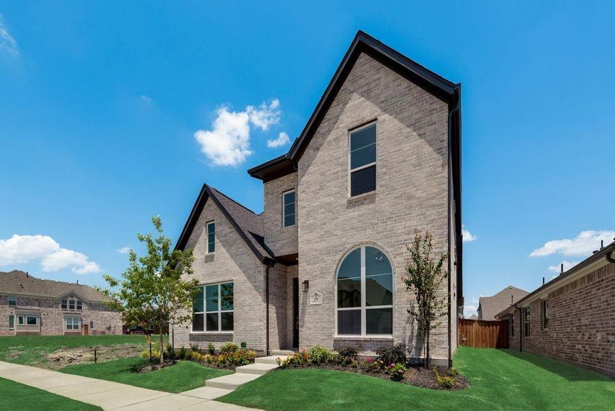Front exterior of a new home in Edgewater, Fate, TX, highlighting curb appeal (Image 2). Front exterior of a new home in Edgewater, Fate, TX, highlighting curb appeal (Image 2).
