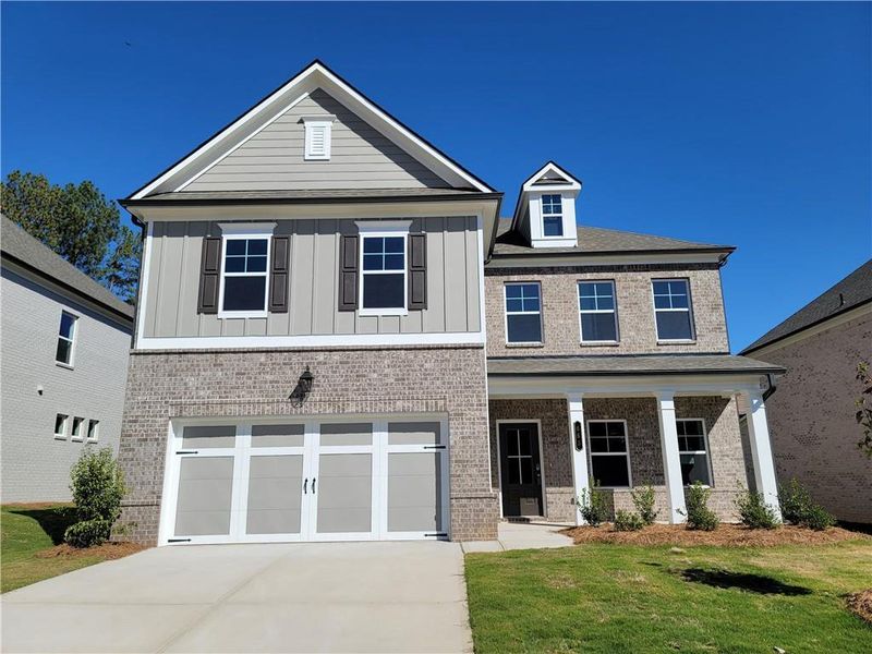 Front exterior of a new home in Pinecrest Ridge, Dacula, GA, highlighting curb appeal (Image 2). Front exterior of a new home in Pinecrest Ridge, Dacula, GA, highlighting curb appeal (Image 2).